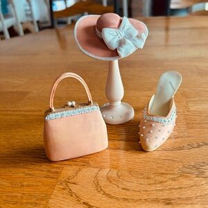 “WHATNOT” miniature handbag, hat with stand and one high heel shoe.